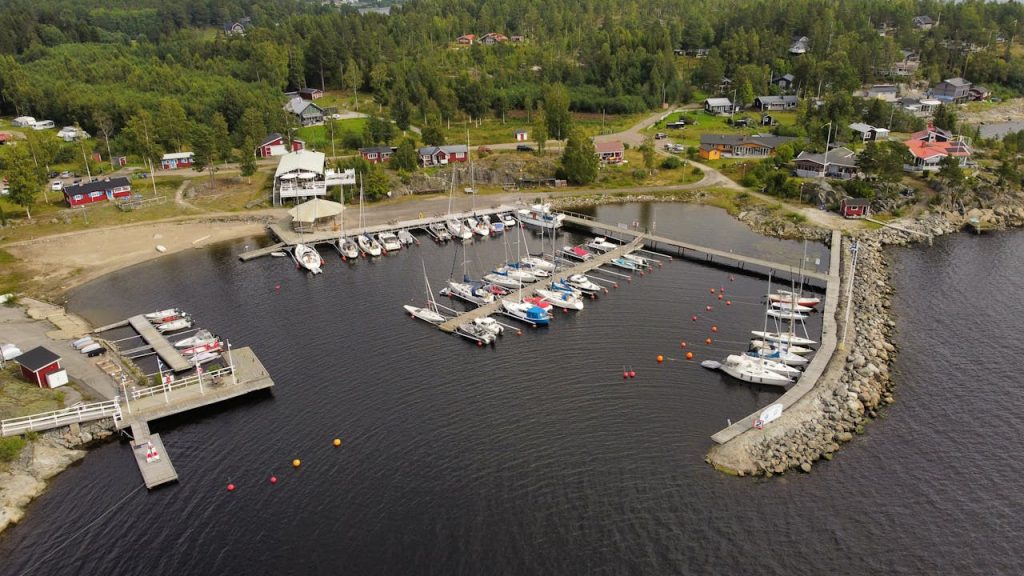 Scenic aerial photo of a harbor in Västernorrlands län, Sweden with boats and lush greenery.